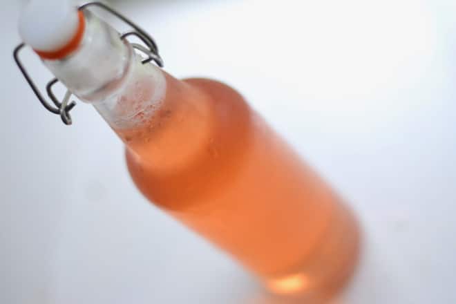 A bottle of fizzy fermented kombucha scoby DIY organic gut health