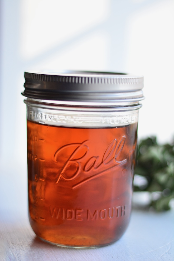 pint size wide mouth mason jar filled with homemade mint simple syrup