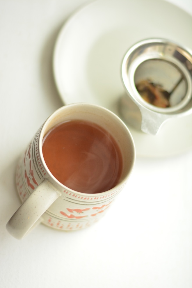 growing herbs for tea, like the ones steeping in this mug of hot water, is rewarding and easy