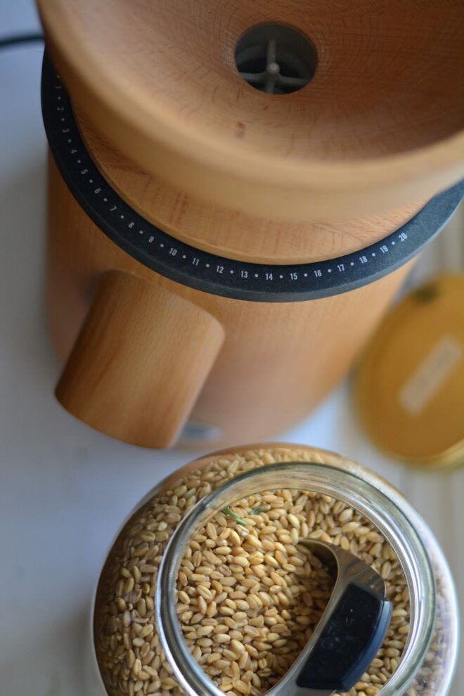 mockmill grain mill with jar of wheat berries to make bread