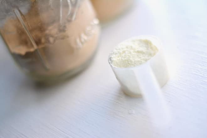 jars of powders and a scoop of collagen powder for making an iced latte