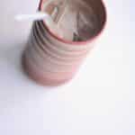 an iced latte in a brown handmade pottery tumbler with a glass straw