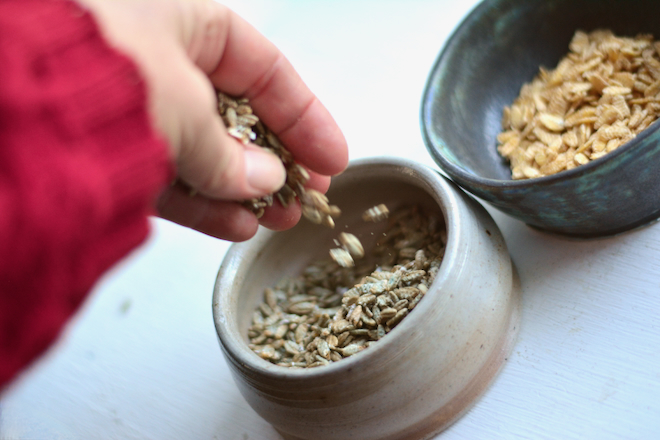 flaked rye and rolled oats in pottery bowls