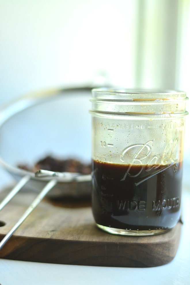 soda syrup for Dr Pepper recipe. Homemade soda made with soda syrup with strainer in background