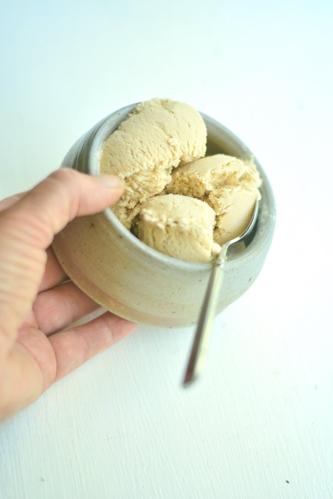 a bowl of ice cream made with espresso in someone's hand