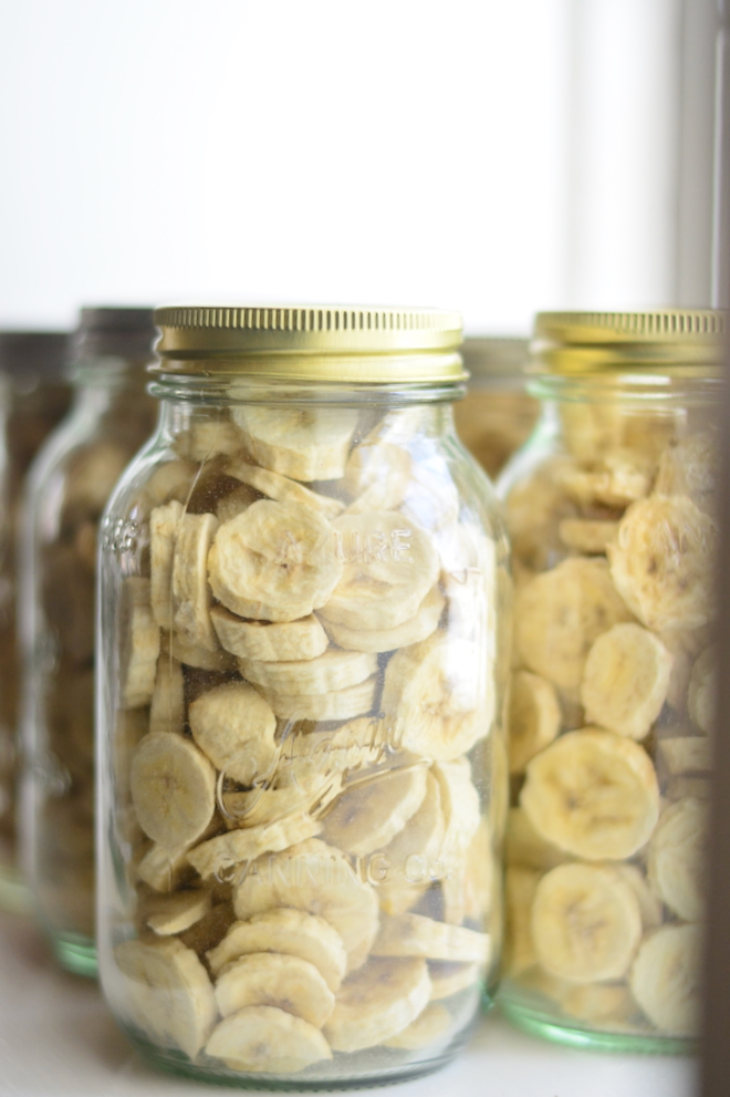 a full shelf of freeze dried banana chips in mason jars with lids