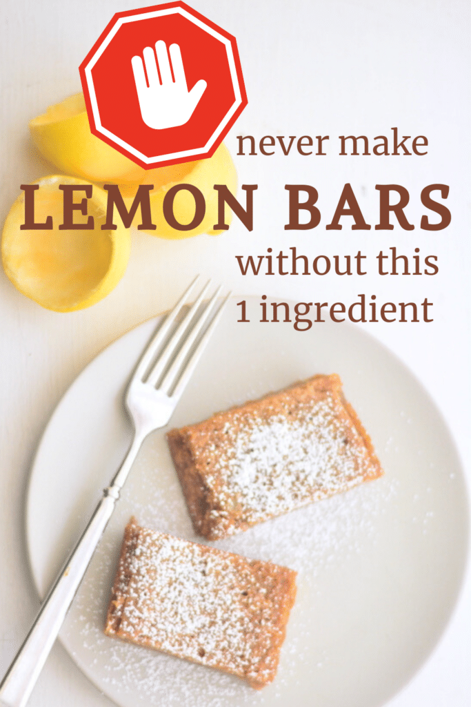 fresh squeezed lemons and a plate of einkorn lemon bars dusted with confectioners sugar