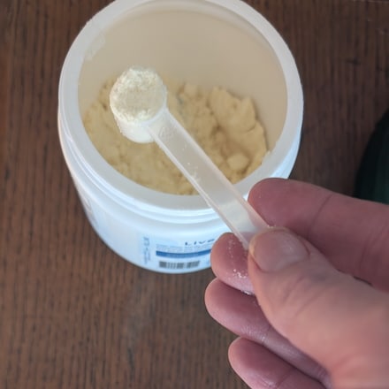 colostrum powder in a scoop