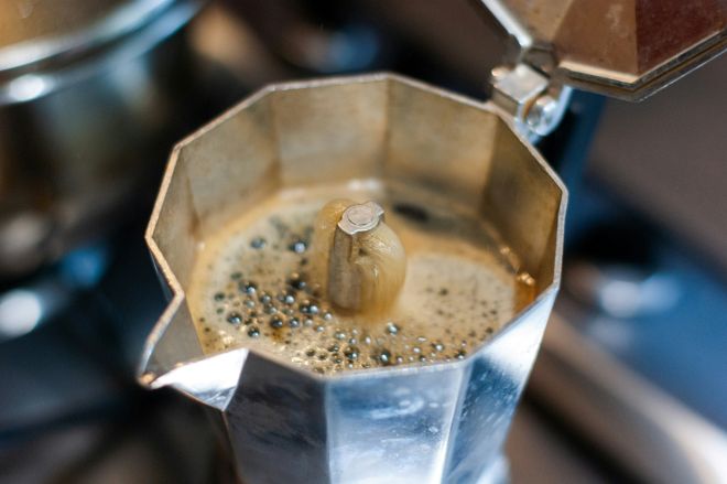 espresso gurgling in a moka pot making espresso at home