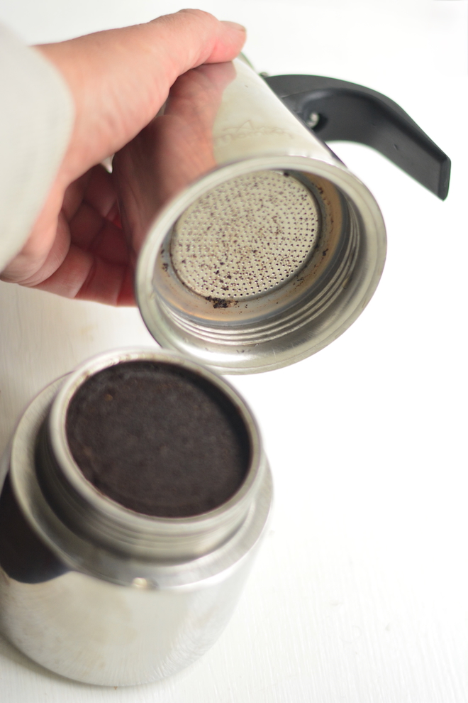 an opened moka pot after making espresso, before it is cleaned