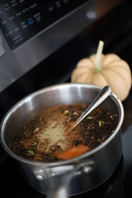 chai concentrate on stove simmering in sauce pan, ingredients for pumpkin chai