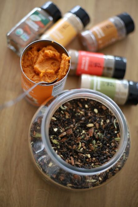 ingredients to make pumpkin chai concentrate, including nutmeg, ginger, cardamom, cloves, cinnamon, pumpkin pure, and masala chai tea (loose leaf)